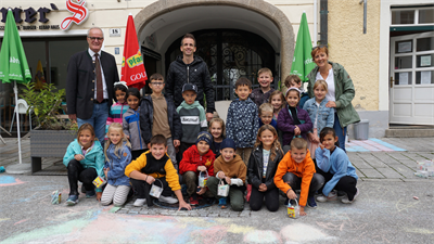 Bürgermeister Christian Gratzl und Umweltstadtrat Harald Schuh mit einer Schulklasse bei der Straßenmalaktion in der Eisengasse.
